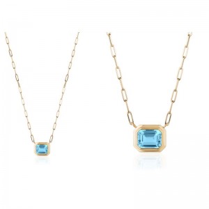 Blue Topaz Emerald Cut Bezel Pendant In 18K Yellow Gold.
