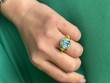 Blue Topaz & Peridot 3 Stone Emerald Cut Ring with Diamond in 18K Yellow Gold.